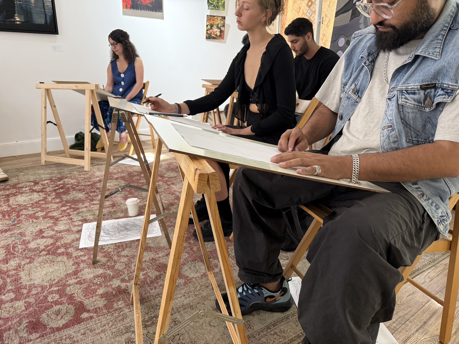 Participants seated around the live model during an InSketch session