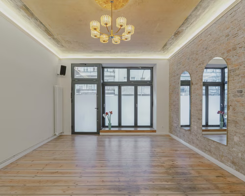 The empty InSketch venue with wooden floors, large windows and an exposed-brick wall
